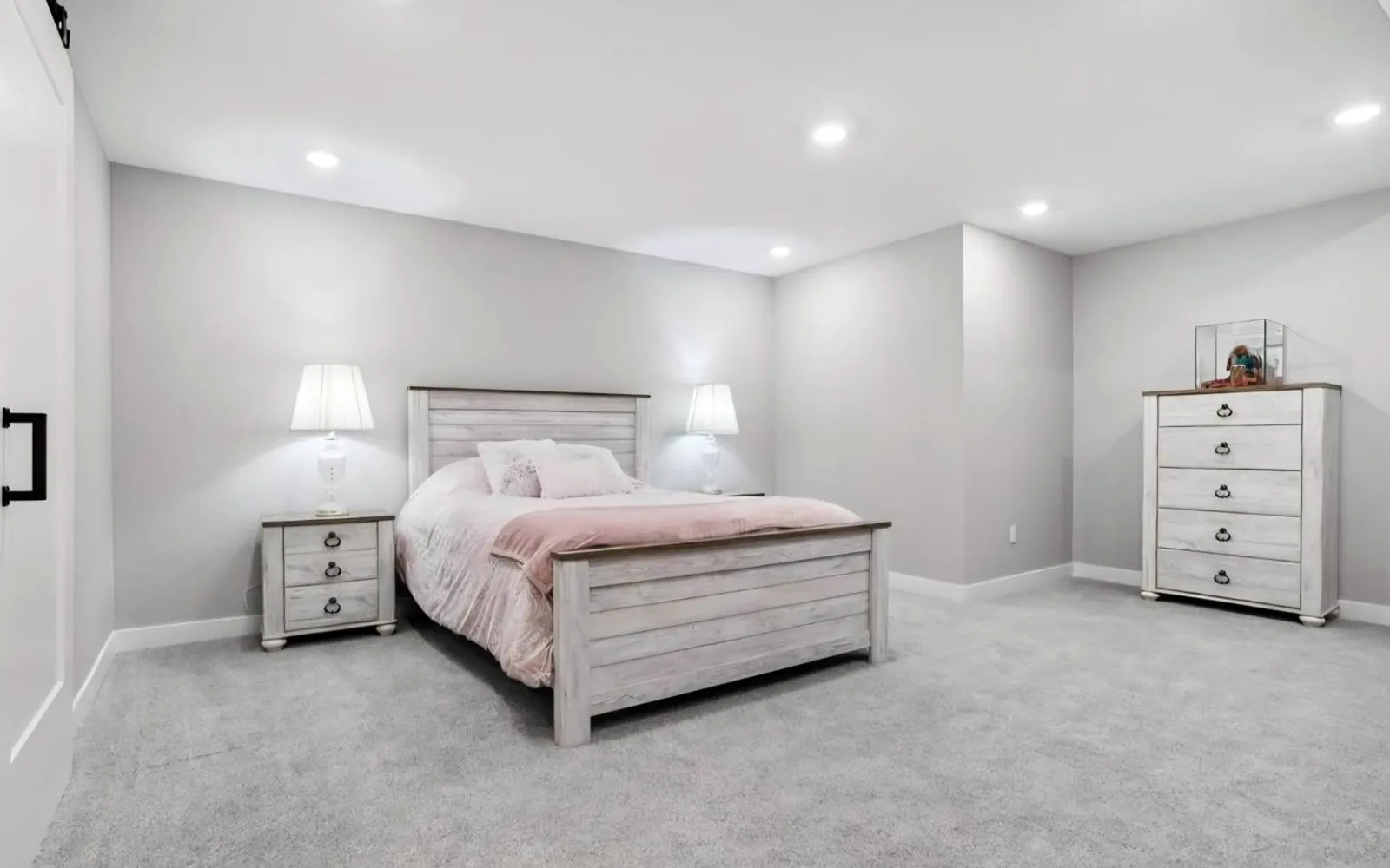 Finished basement bedroom with new carpet, recessed lighting and light grey walls